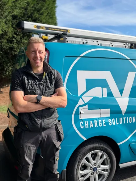 Stephen Jones, founder of EV Charge Solutions, standing in front of the company van